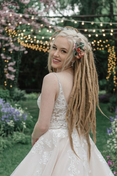 Discover the stunning beauty of this elegant dreadlock updo, a perfect choice for modern brides seeking unique wedding hairstyles. This mesmerizing style features intricately twisted dreadlocks artfully arranged to create a chic and sophisticated look. Accentuated with delicate floral accessories, this bridal hairstyle beautifully blends cultural richness and personal flair, ensuring you stand out on your special day. #weddinghairstyles Bridal Dreadlock Hairstyles, Twisted Dreadlocks, Dreadlock Updo, Unique Wedding Hairstyles, Bridal Hairstyle, Dread Hairstyles, Dreadlock Hairstyles, Floral Accessories, Unique Wedding