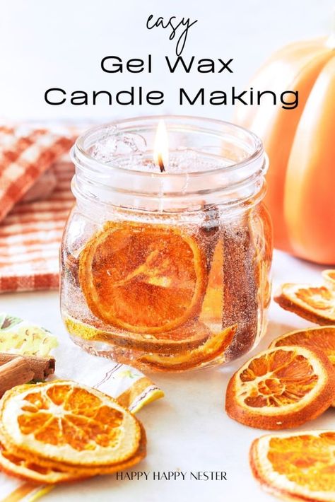 An image showcasing a lit candle in a glass jar with dried orange slices embedded in the gel wax. The text reads "Easy Gel Wax Candle Making." There are additional dried orange slices and a striped cloth in the background. The source is noted as "Happy Happy Nester. Gel Wax Candles Diy, Simple Fall Crafts, Gel Candle Diy, Wax Candle Making, Gel Wax Candles, Fall Crafts For Adults, Diy Cinnamon, Candle Printable, Wax Candles Diy