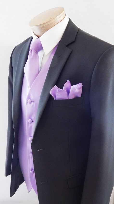 Silk Feel Microfiber Satin Full Back And Adjustable Vest set. The Vest Is Fully Lined With Matching Material Covered Buttons. It Comes With Two Outside Lined Pockets A Regular Four In Hand Tie Measurements Are 58 Inches Long And 3 1/4 Inch Wide With The Matching Fabric Pocket Square. Purple Suits For Men Quince, Light Purple Tuxedo For Men, Lilac Quinceanera Chambelanes, Black Suit With Lilac Tie, Black And Lavender Tuxedo, Black Suit Lilac Tie, Lavender Suit Men Wedding, Chambalans Outfits Quince Purple, Purple Quince Chambelanes