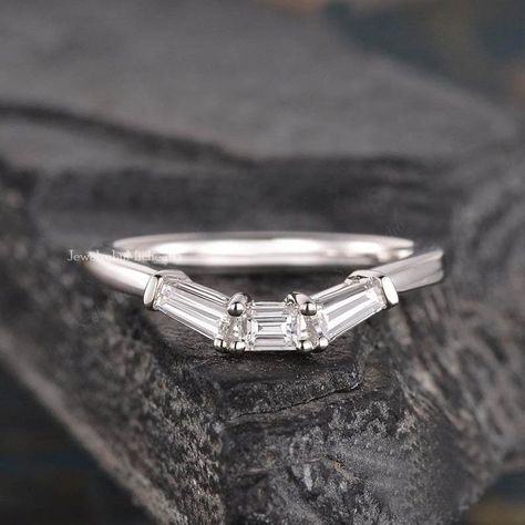 "Welcome to our shop \"JewelrybyMichealB\"  ● Baguette Moissanite Wedding Band, White Gold Stackable Band, Curved Matching Band, Delicate Dainty Ring, Promise Ring. Item Description and specifications: ● Main Stone Details  -  Type      : Moissanite  -  Shape   :- Baguette Cut  - Weight   :- 0.227 CT   -  Color     :- White -  Clarity   :- VVS ● Metal Details - Metal type: Silver, Gold, Platinum - Metal Purity: 925, 10k, 14k, 18k - Metal Tone: White, Rose, Yellow - Metal Stamp: Yes ● Customize O White Gold Wedding Bands Women, Emerald Cut Wedding Band, Baguette Wedding Rings, Gold Wedding Band Women, Baguette Diamond Wedding Band, Wedding Band White Gold, Baguette Wedding Band, Wedding Band Women, White Gold Wedding Band