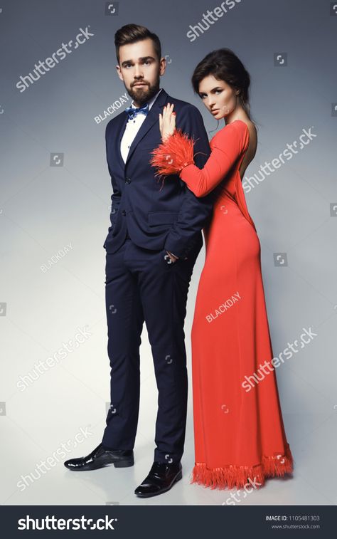 Attractive and well-dressed couple posing in studio. Woman in beautiful red dress and man wearing blue classical suit with bow tie. Woman#studio#red#beautiful Suit With Bow Tie, Bow Tie Suit, Beautiful Red Dresses, Courthouse Wedding, Business Icons, Icons Design, Model Release, Cheat Sheets, Logo Design Inspiration