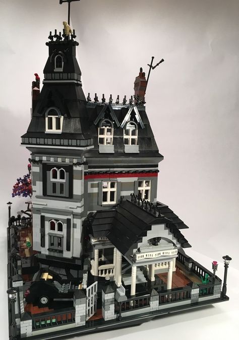 LEGO is reviewing this nifty Addams Family mansion as a possible box set. It even has Morticia on her rattan chair with a black fan. Construction details: • 3 floor Mansion, each floor is a removable segment • Sits on two 15”x10” base plates (for a total of 3,072 studs) • The Mansion separates into… Lego House Exterior, Addams Family Mansion, Lego Mansion, Lego Haunted House, Gothic Noir, Lego Tree, Family Mansion, Lego Houses, Lego Bedroom