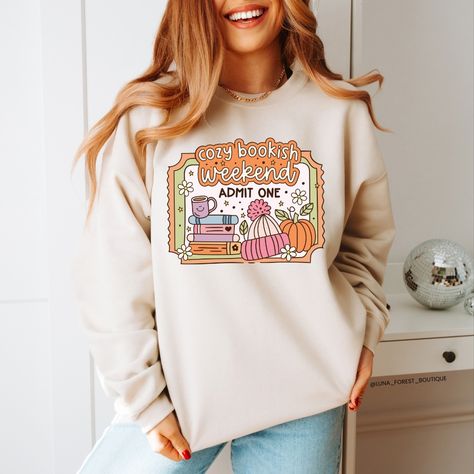 Cozy up with your favourite book in our Cozy Bookish Weekend Sweater 🧡🍵📖 Design by @shop.svgsociety 🫶 Weekend Sweater, Sweater Design, Handmade Clothes, Sweater Weather, Heat Transfer Vinyl, Heat Press, Colorful Sweaters, Favorite Books, Environmentally Friendly