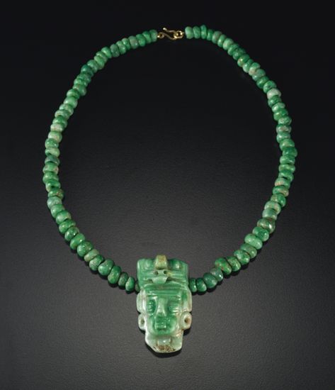 MAYA JADE NECKLACE WITH HEAD PENDANT,  LATE CLASSIC, CA. A.D. 550-950    the dignitary's head with large eyes, full lips, and wearing earrings, adorned with a massive avian head as headdress, with carefully drilled nostrils, short downturned beak and rounded eyes; pierced laterally for suspension and strung with a suite of brilliant apple green jade beads. Jewelry Facts, Mayan Art, Ancient Jewellery, Ancient Mayan, Jade Necklace, Jade Bracelet, Jade Carving, Ancient Jewelry, Jade Jewelry