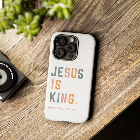 Celebrate the faith-filled journey of your beloved daughter with the Bible Verse:  "Jesus is King" Phone Case, a perfect blend of style and spirituality. This stunning phone cover not only protects her device but also serves as a constant reminder of her divine identity. Crafted with care, this phone case features a sleek and durable design, ensuring both protection and elegance. The vibrant design showcases a delicate blend of aesthetics and faith, making it a meaningful accessory for daily use Bible Phone Cases, Christian Iphone Cases, Christian Shirts Designs, Gifts For Daughter, Jesus Is King, Trendy Phone Cases, Christian Bible Quotes, Unique Phone Case, Christian Quotes Inspirational