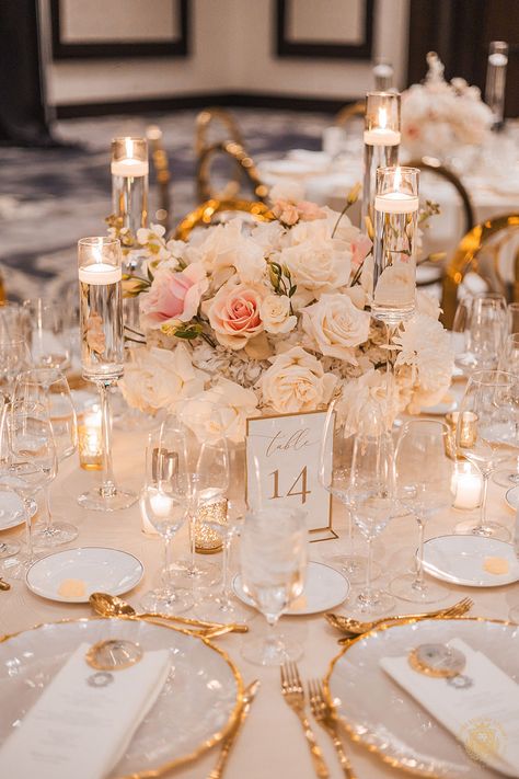 Alexa and Rami’s wedding showcased a glamorous white and gold design with blush accents. The reception featured dramatic table centerpieces included a mix of crystal and white floral bridges, lush floral table runners & tall candle towers. | Floral, Decor, Production & Design: Royal Luxury Events / Photo: Nate Messarra Photography | wedding table centerpieces, low floral arrangements, wedding reception decor, pink wedding flowers, elegant, wedding candles, floating candles, wedding inspiration Timeless Wedding Decor Round Table, Wedding Ideas Glamorous, Gold And Crystal Wedding Decor, Blush Gold And White Wedding, Romantic Weddings Decoration, Round Table Floral Centerpieces Wedding, Flowers And Floating Candle Centerpieces, White And Gold Table Centerpieces, White Pink And Gold Wedding Decor