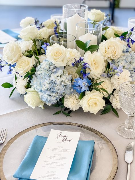 Blue And White Flower Centrepiece, Blue Theme Wedding Centerpieces, White Blue Hydrangea Centerpiece, Blue Hydrangea Centerpieces With Candles, Blue Roses Centerpieces, Blue Carnation Centerpieces, Tall Blue Floral Centerpieces, Blue And Silver Floral Arrangements, Blue And White Roses Centerpieces