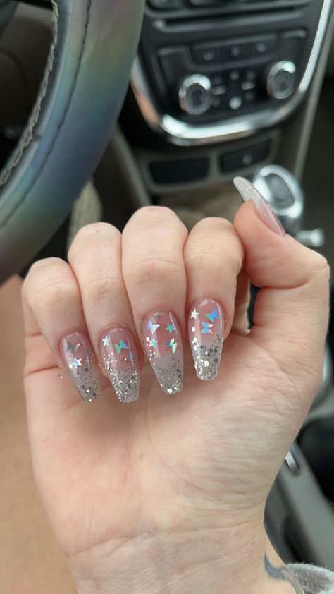 Butterfly glittery silver acrylic nail inspiration Butterfly Nails Glitter, Gray Prom Nails, Silver Nails With Butterflies, Sparkly Butterfly Nails, Silver Butterfly Nails, Glittery Butterfly Nails, Silver And Blue Butterfly Nails, Shiny Nails Glitter, Butterfly Sequin Nails