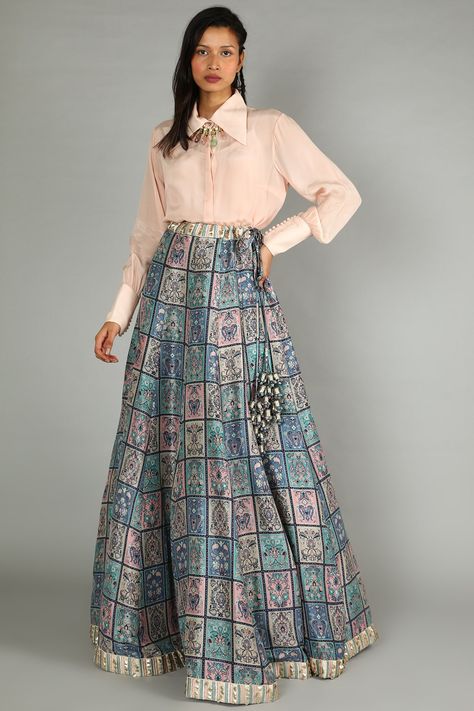 Featuring a blue and blush pink lehenga in satin silk base with galeecha patchwork print. It is paired with a matching blush pink shirt having gathered sleeves.  FIT: Fitted at bust and waist. COMPOSITION: Satin silk. CARE: Dry clean only. Shirt And Lehenga Outfit, Latest Indo Western Outfits For Women, Modern Lehenga Designs, Indo Western Outfits For Women, Pink Shirt Outfit, Satin Skirt Outfit, Choli Dress, Printed Lehenga, Trendy Outfits Indian