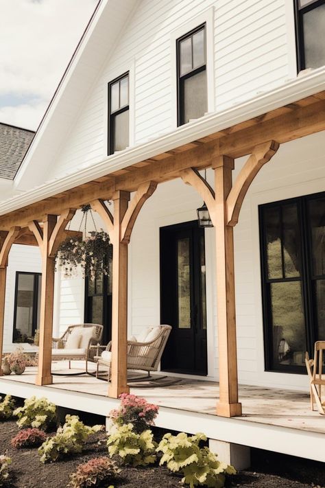 40 Farmhouse Porch Columns To Achieve a Rustic Entryway! Porch With Corbels, Houses With Cedar Posts Front Porches, Wood Beam Entryway Front Porches, Earthy Front Porch, Country Home Outdoor Ideas, Farmhouse Rambler Exterior, Porch Beam Stain Colors, Front Door White House Black Shutters, Craftsman Front Porch Columns