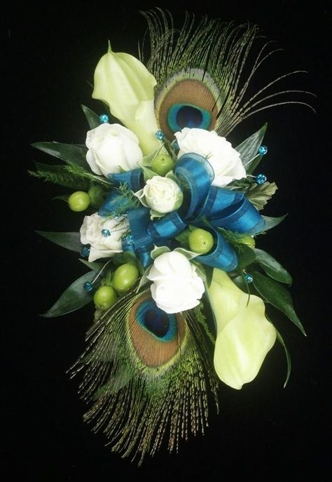 Peacock Feather Wrist Corsage - cala lilies, hypericum berries, sweetheart roses with a teal ribbon.  Created by Jane's Flower Shoppe, New Holland, PA Corsage Homecoming, Peacock Feather Wedding Bouquet, Calla Lily Peacock Feather Bouquet, Bouquet With Peacock Feathers, Wedding Bouquet With Peacock Feathers, Corsage With Peacock Feather, Peacock Wedding Inspiration, Cala Lilies, Corsage Ideas