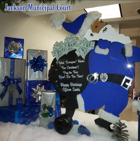 The front window of Court Services @ Jackson Municipal Court displayed Officer Santa a wood prop made by myself. The message on his Santa Sack read, “I want everyone home for Christmas, pay the fine don’t do the time.”He was the highlight to all that saw him. Several customers were seen taking pictures of Santa and the display and coworkers from other divisions came by to see the decor. One customer said seeing the decorations when you come to the police station lifts your spirits. Police Christmas Decorations, Police Christmas, Wood Props, Christmas Float, Prop Making, Home For Christmas, Santa Sack, Police Station, Holiday Lights