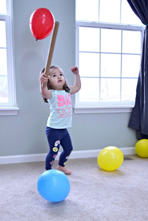 A little girl playing balloon baseball for a balloon olympics is trying to hit a red balloon floating in the air with a cardboard tube Balloon Activities, Kid Games Indoor, Sports Activities For Kids, Toddler Sports, Indoor Activities For Toddlers, Water Games For Kids, Summer Fun List, Indoor Activities For Kids, Games For Toddlers