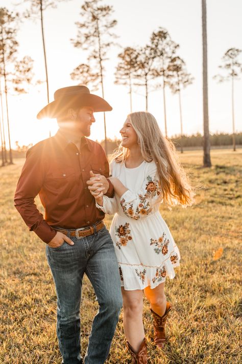 Love, engagement photos, engagement ring, engagement dress, white dress, embroidered, field, pasture, country, western, boho, wedding, wedding venue,  cowboy hat, cowboy boots, pearl snap, turquoise jewelry, horse farm, outdoors, sunset Couples Photoshoot Farm, Couple Farm Photoshoot, Ranch Couple Photoshoot, Country Family Photos, Couple Horse Photography, Country Themed Couple Photos, Engagement Photos With Cattle, Western Engagement Photos, Farm Engagement Photos