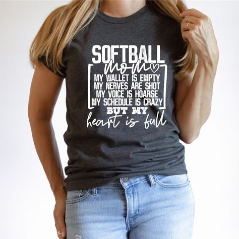 "PLEASE NOTE SHIPPING TIME IS CURRENTLY 1-3 WEEKS FOR ALL ITEMS IN OUR SHOP FOR ORDERS PLACED 12/26/2023 THROUGH 1/07/2024  This Softball Mom Shirt is the perfect way to show off your love and support for your daughter's softball team. This Bella Canvas unisex t-shirt comes in your choice of color, and features a cute and funny message that reads, \"SOFTBALL MOM - My wallet is empty, my nerves are shot, my voice is hoarse, my schedule is crazy but my heart is full\". Made from high-quality mater Funny Softball Mom Shirts, Softball Pitcher Shirts, Baseball And Softball Mom Shirts, Softball Mom Shirt Ideas, Softball Tshirts, Softball Apparel, Softball Shirt Designs, Travel Softball, Softball Mom Shirt