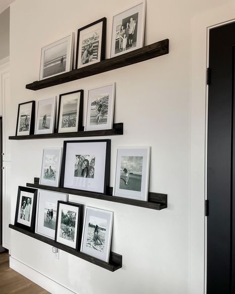 Photo Wall Ideas Entryway, Frame Arrangement On Wall Bedroom, Photo Frame Shelf Display, Black Photo Ledge, Black And White Wall Ideas, Black And White Framed Photos On Wall, Living Room Family Picture Wall, Photo Wall Ideas Bedroom, Photo Shelf Display