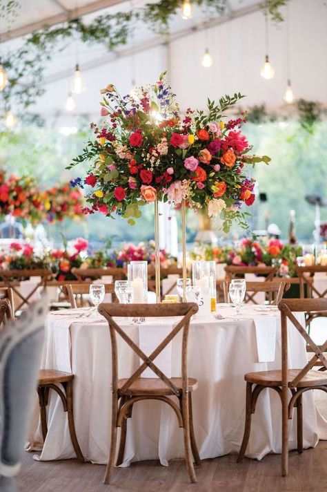 Wedding Table Settings With Candles, Bright Wedding Aesthetic, Wildflower Tent Wedding, Raised Floral Centerpieces, Wedding Decorations Wildflowers, Colorful Wedding Reception Decor, Wildflower Wedding Theme Receptions, Wildflower Wedding Theme Table Settings, Wedding Centre Piece Ideas