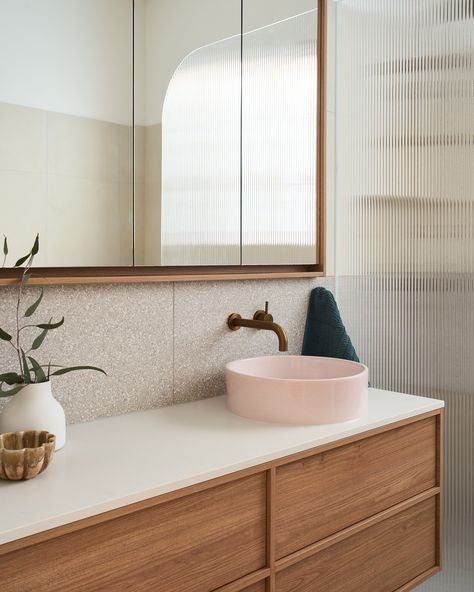 Unique bathroom ideas, featuring a pink basin for a pop of colour, perfectly complementing the bronze tapware and terrazzo tiles. #BathroomInspiration #TerrazzoTiles

Reece featured products 🛁:
Kado Aspect vanity, Kado mirror cabinet, Kado Lux rimless toilet pan, Posh Solus back to corner bath, Sussex Scala tapware, Milli Mood Edit twin shower and accessories.

IG credit 📷: @indulgerenovation Terrazzo Powder Room, Pink Terrazzo Bathroom, Bronze Tapware, Terrazzo Tiles Bathroom, Terrazzo Vanity, Unique Bathroom Ideas, Rimless Toilet, Ensuite Ideas, Terrazzo Bathroom