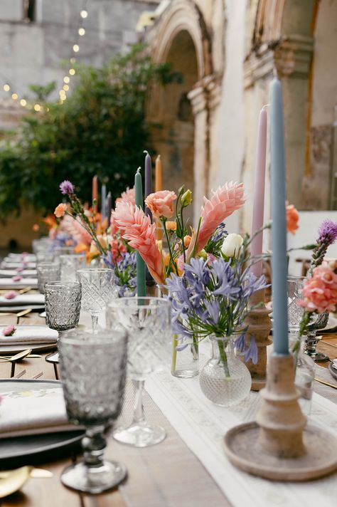 Pastel colorful reception table with vibrant florals and taper candles #pastelwedding #colorfulwedding #pastelcandles #pastelflorals #colorfulflorals Colored Candlesticks, Colorful Reception, Marquee Decor, Taper Candles Wedding, Colored Taper Candles, Pastel Candle, Vibrant Florals, Reception Tables, Reception Flowers