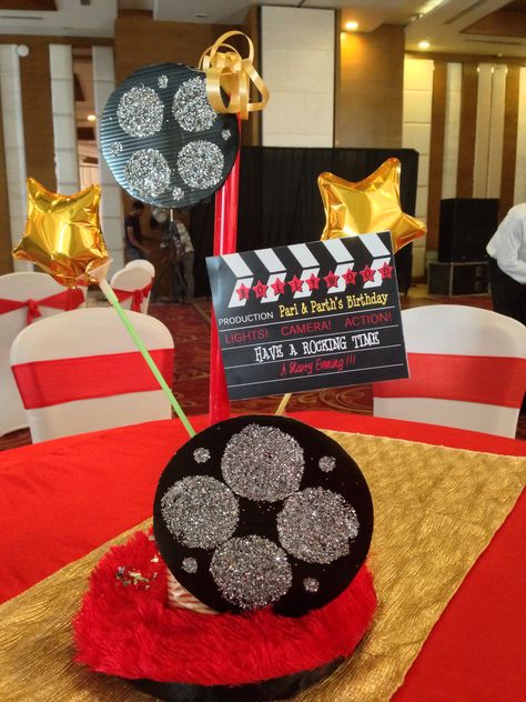 Bollywood theme party - table centrepiece with discs and clapboard and a touch of glam with fur n gold stars By Hosting Happinez #bollywood #themeparty #birthday #celebrations #anniversary #kids Bollywood Theme Birthday Party, Bollywood Retro Theme Party Decoration, Bollywood Theme Party Decoration, Retro Bollywood Theme Party, Retro Theme Party Decoration, Retro Bollywood Theme, Bollywood Party Decorations, Indian Party Themes, Retro Theme Party