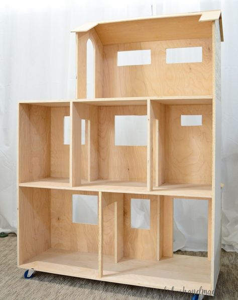 Build a beautiful handmade dollhouse with these easy DIY plans. Use these handmade dollhouse plans to make the perfect Christmas present this year. The 4' dollhouse is built out of plywood for a sturdy house Dollhouse Furniture Plans, Dollhouse Woodworking Plans, Dollhouse Plans, Wooden Doll House, Barbie House Furniture, Diy Barbie House, Dollhouse Diy, Handmade Dollhouse, Doll House Plans