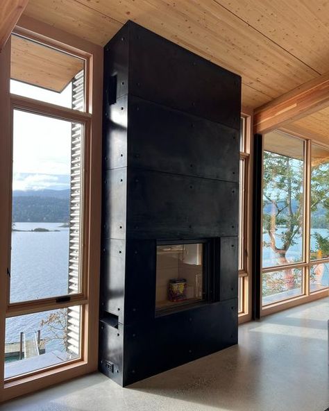 Broadwell Metal Company on Instagram: "#blackenedsteel @stuv_america fireplace wrap for @wilcosaltspring all 3/16” hot rolled steel plate with 3/16”reveal seams, custom vents and patina treated fasteners finish it off. Not a bad view in the background there also!!! - - - - - - - #yyj #victoriabc #saltspringisland #welding #metal #metalfabrication #arcitecture #architecturametal #finemetalwork #interiordesign #steel #patina" Steel Wrapped Fireplace, Hot Rolled Steel Fireplace, Moss Yard, Steel Patina, Perforated Metal Panel, Yard Remodel, Steel Fireplace, Hot Rolled Steel, Montana Homes