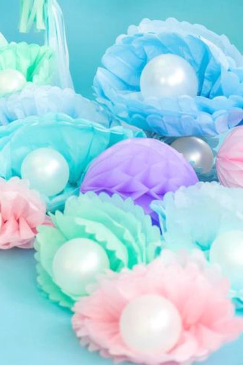 You won't believe this amazing mermaid party decoration!  These tissue paper pom poms with pearl balloons look just like oyster shells and look absolutely fabulous! Scatter them on the floor beside your dessert table or use them as a centerpiece. They are so beautiful that you just can't go wrong! See more party ideas and share yours at CatchMyParty.com Pearl Balloons, Mermaid Party Supplies, Ocean Birthday Party, Mermaid Birthday Party Decorations, Mermaid Theme Birthday Party, Ocean Birthday, Mermaid Party Decorations, Tissue Paper Pom Poms, Sea Birthday Party