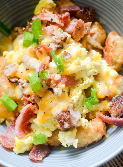 Jump to Recipe·Print Recipe Country Breakfast Bowl – a hearty breakfast bowl topped with scrambled eggs, bacon, sausage and melted cheese on top! Ever eaten at Perkins before? They have this dish there called Country Breakfast Bowl. It’s got everything your heart loves about breakfast food. Eggs, Tator Tots, bacon, sausage, and to make it … Burritos Vegetarian, Tator Tot Breakfast, Freeze Breakfast, Burritos Healthy, Burritos Freezer, Breakfast Bowl Egg, Freezable Breakfast, Scrambled Eggs Bacon, Sandwiches Breakfast