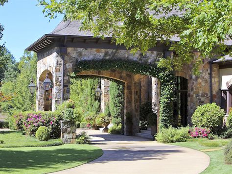 Once in the shade of this handsome stone portico, patio stairs lead to large, welcoming glass-paned doors and windows for an entryway bathed in soft, natural light. Swinging Bed, Casa Garage, Porte Cochere, Casa Country, Country French, Front Entrances, Stone House, Large Homes, Home Staging