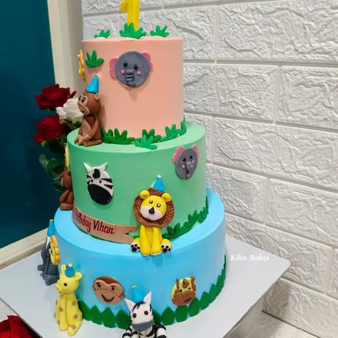 Baked with love 💕 Celebrate your little one's first birthday with a spectacular three-tier vanilla cake, adorned with a whimsical safari theme. Each tier is delicately layered with moist vanilla cake, offering a deliciously sweet foundation for your celebration. The cake is beautifully decorated with vibrant fondant accents, including intricate 2D and 3D animal toppers such as elephants, zebras, monkeys, lions, and giraffes, adding a touch of playful charm to the design. Sprinkled throughout... Single Layer Animal Cake, 3 Tier Safari Themed Cake, Elephant First Birthday Cake, Jungle Theme 2 Tier Cake, 1st Birthday Cake Elephant, Moist Vanilla Cake, Daily Yoga Workout, Baked With Love, Daily Yoga