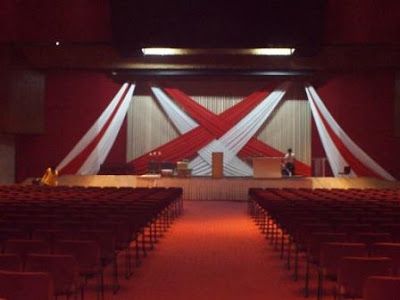 Simple Church Stage Designs | Feb 27 2011 Stage Backdrop Design Red and White Drapes at The Feast ... Fabric Stage Design, Reception Stage Backdrop, Church Stage Design Ideas Backdrops, Wedding Reception Stage, Backdrop Draping, Graduation Stage, Stage Backdrop Design, Draping Ideas, Reception Stage