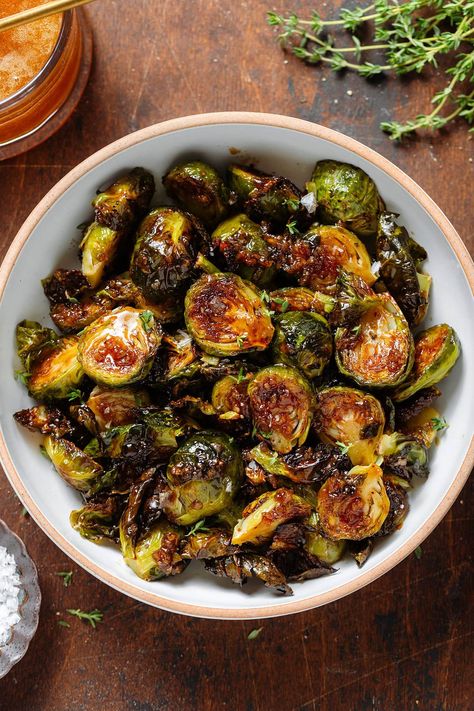 These Honey Balsamic Brussels Sprouts are the perfect balance between sweet and salty. They're crispy, flavorful, and so simple! They're easy enough to be served as a side for a weeknight dinner but they taste fancy enough to be a part of your holiday table! They make a great fall side dish for any occasion. Fancy Dinner Party Meals, Brussel Sprouts For Thanksgiving, Brussels Sprouts With Cheese, Thanksgiving Side Dishes Brussel Sprouts, Brussels Sprout Roasted, Honey Glaze Brussel Sprouts, Crispy Balsamic Brussel Sprouts, Tahini Brussel Sprouts, Steak With Brussel Sprouts