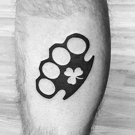 Negative Space Clover With Brass Knuckles Mens Black Ink Irish Leg Tattoos Brass Knuckle Tattoo, Knuckles Tattoo, Knuckle Tattoo, Negative Space Tattoo, Clover Tattoo, Brass Knuckle, Tattoos Meaning, Knuckle Tattoos, Irish Tattoos