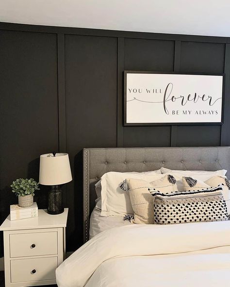 This adorable farmhouse-style bedroom features a classic combination of gray, black, and white to achieve a cozy aesthetic. The black board and batten walls complement the grey headboard and fluffy white duvet and pillows. A cute white nightstand is placed next to the bed. Fluffy White Duvet, Black Board And Batten Wall, Grey Black And White Bedroom, Black Board And Batten, Gray Accent Wall Bedroom, Wall Behind Bed, Rectangle Bedroom, Monochrome Bedroom, Grey Accent Wall