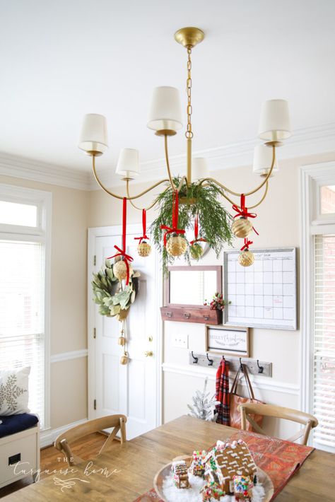 Christmas Balls On Chandelier, Christmas Ornaments Hanging From Chandelier, Christmas Greenery Chandelier, Light Fixture Decorations For Christmas, Holiday Chandelier Ideas, Hang Ornaments From Chandelier, Christmas Garland On Chandelier, Bows On Chandelier Christmas, Christmas Decor Dining Room Light