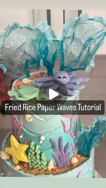 Dominique (Nika) Spencer, A Whisk Worth Tasting LLC on Instagram: "#tiptuesday 🌊 Fried Rice Paper Waves Tutorial!  Use spring roll wrappers/rice paper. I get mine from the Korean market but they are also available on Amazon and major grocery stores   💙 Soak them in a plate of water colored with gel color (I use @americolor sky blue) for about 3-5 mins until completely pliable.   Set them out on wrinkled parchment paper to dry for 24-48 hours. I wrap them around a toothpick while wet so I can easily stick them in my cake.   Once dry, fry them in hot vegetable oil and voila! 🌊   Will you try this?! Follow @whiskworthtasting for more cake decorating tips! * * * * * * * * #cakemaker #cakesofinstagram #caker #cakedecorating #caketips #cakeartist #edibleart #undertheseacake #onederthesea #hom Rice Paper Waves Cake, Rice Paper For Cake Decorating, Wave Cake Ideas, Rice Paper Tutorial, Rice Paper Cake Decorations, Fried Rice Paper, Waves Cake, Paper Waves, Dolphin Birthday