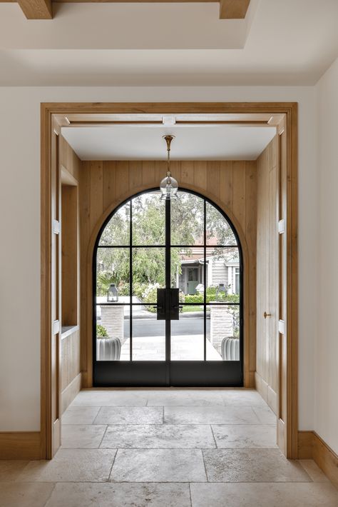 In the entrance of this Newport Beach home, custom blackened-steel doors from Euroline Steel Windows & Doors play off walls sheathed in plain-sawn French oak boards and Exquisite Surfaces limestone flooring. The glass tulip pendant is from Cox London. M Elle Design, Eric Olsen, Newport Beach Homes, Cedar Shingle Roof, Entry Tile, Limestone Flooring, Entrance Door Design, Architecture Home, Happy Ending