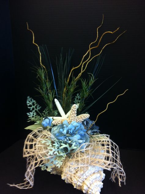 Ocean blue custom floral by Andrea for Michaels Laverne Nautical Floral Arrangements, Under The Sea Floral Arrangements, Nautical Flower Arrangements, Beach Floral Arrangements, Shell Arrangements, Beach Arrangements, Coastal Wreath, Beach Wedding Centerpieces, Shell Decorations