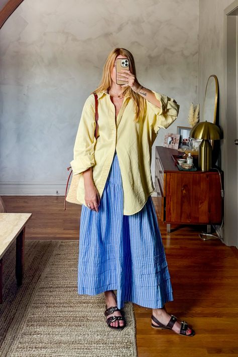 Big shirt, big skirt is my vibe for summer. I love this Dôen sebastian skirt in blue stripe, it is so soft and comfortable. I paired this midi skirt with a vintage men's oversized button down and stuck with blue and yellow for color blocking. This is an easy summer outfit that is chic and perfect for lunch dates or running to the farmers market. #coastalaesthetic #europeansummeraesthetic #sezanelovers • European summer outfits • french girl fashion • casual chic outfit ideas • butter yellow • Oversized Shirt And Midi Skirt Outfit, Doen Sebastian Skirt, Long Skirt Button Up Shirt, How To Style Blue Skirt, Full Coverage Summer Outfit, Button Down Shirt Over Dress Outfit, Button Up Shirt Skirt Outfit, Running Skirt Outfit, Big Skirt Outfit