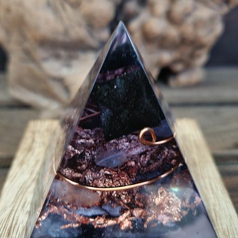 Orgonite pyramid....  I am happy to be learning a new craft working with epoxy resin and crystals to create these beautiful orgonite pyramids!  Orgonite is a storehouse for Universal energy and known to be a EMF blocking/cleansing tool that also can be used to enhance your personal energy when held or kept in your personal proximity. A combination of organic and inorganic materials, mixed together in layers and compressed in an environment (in this case, resin which is organic), has been found to create an energy field all its own.  These pyramids are not only beautiful to look at and used for decoration but they also enhance positive energy flow as well as neutralize negative energy caused by electromagnetic frequencies from cell towers, electronics, low vibrations, etc. Made with epoxy r Case Resin, Universal Energy, Cell Tower, Orgonite Pyramids, Personal Energy, Clear Negative Energy, Meditation Space, Energy Flow, Energy Field