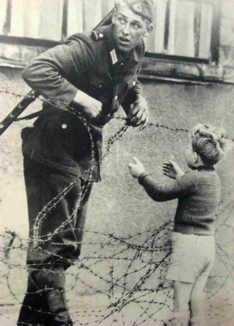 East German soldier helps a little boy sneak across the Berlin Wall, 1961 German Soldier, Foto Langka, The Soldier, Faith In Humanity Restored, Humanity Restored, Manama, Photo Caption, Berlin Wall, Anne Frank