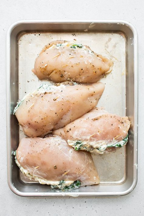 This spinach stuffed chicken breast will be one of your new favorite recipes — and for good reason! No one can resist juicy chicken breasts stuffed with an oozy, cheesy spinach filling. Cheesy Spinach Chicken Bake, Spinach And Feta Stuffed Chicken, Spinach Stuffed Chicken Breast Recipes, Spinach Stuffed Chicken Breast, Spinach Filling, Cream Cheese Spinach, Stuffed Chicken Breast Spinach, Low Carb Meats, Cheese Stuffed Chicken Breast