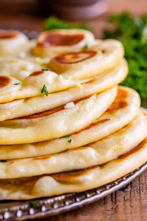 Homemade Naan Bread Recipe from The Food Charlatan. Make restaurant quality Naan Bread at home! If you have never tasted a fresh, tender, buttery homemade naan, you're totally missing out. I will show you just how easy this recipe is to put together and gives you the perfect receptacle for cleaning up all the curry on your plate! Naan Bread Recipe Sour Cream, Naan Bread Recipe No Yogurt, Naan Bread Recipe Easy, Easy Naan, Slow Cooker Beef Curry, Naan Bread Recipe, Homemade Naan, Homemade Naan Bread, Recipes With Naan Bread