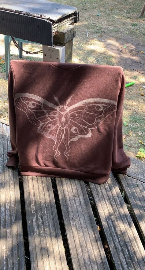 a brown hoodie with a bleached moth design on the back Bleach Moth Hoodie, Bleached Moth Shirt, Brown Bleached Shirt, Bleach Moth Shirt, Tshirts Design Ideas Creative, Bleach Painted Sweatshirt, Moth Bleach Design, Painted Bleach Hoodie, Bleach Hoodie Diy