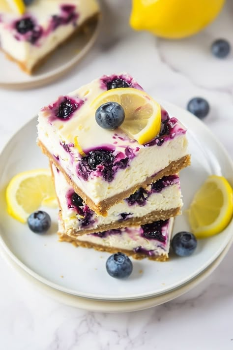 Lemon Blueberry Cheesecake Bars - Insanely Good Lemon Blueberry Dessert Recipes, Lemon Blueberry Cheesecake Bars, Blueberry Cheesecake Bars, Lemon And Blueberry, Tart Flavors, Lemon Blueberry Cheesecake, Lemon Cheesecake Recipes, Lemon Cheesecake Bars, Curd Filling