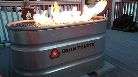 Put your DIY skills to the test with this natural-gas fire pit project.  Get the tutorial at Tractor Supply Co. Propane Tank Fire Pit Diy, Stock Tank Fire Pit, Winery Decorations, Backyard Extension, Backyard Fountain, Diy Stock Tank, Deck Bar, Fire Pit Materials, Galvanized Decor