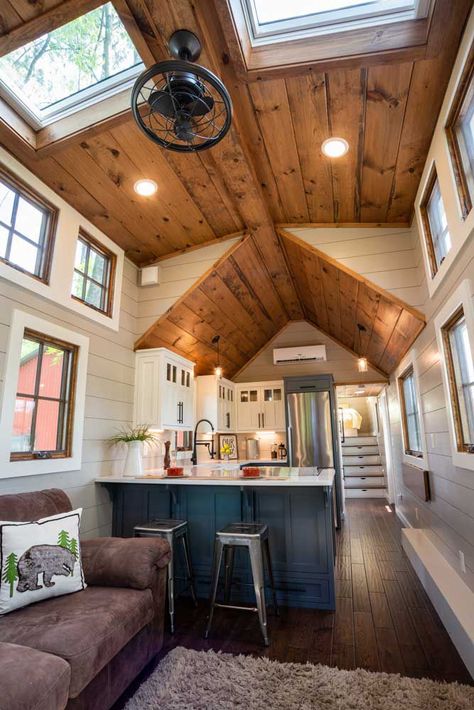 The kitchen features an L-shaped quartz countertop with breakfast bar, white farmhouse sink, blue gray bottom cabinets and white upper cabinets, under cabinet lighting, and a fold down bar under a window. Design Casa Piccola, Timbercraft Tiny Homes, Gooseneck Tiny House, Wohne Im Tiny House, Casa Loft, Tiny House Interior Design, Best Tiny House, Tiny House Inspiration, Living Small