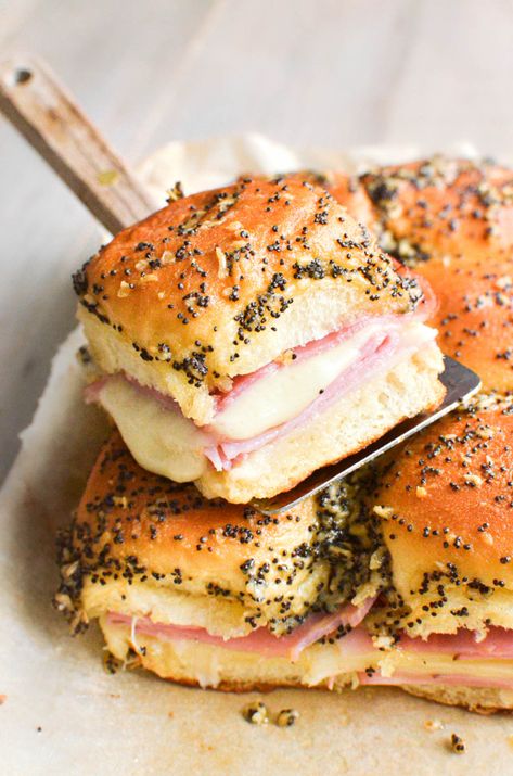 Hot ham and cheese sliders with melty Swiss cheese and a tangy Dijon-butter sauce are the ultimate crowd-pleasing party food! Poppyseed Sliders Ham, Ham And Cheese Howlers, Ham Mini Sandwiches, Ham And Swiss Cheese Sandwiches, Hot Sliders Recipes, Hal And Cheese Sliders Recipe, Smoked Ham And Cheese Sliders, Overnight Ham And Cheese Sliders, Ham Cheddar Sliders