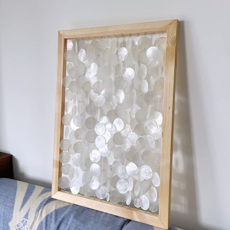 PRICES MAY VARY. PLEASE NOTICE THIS IS ACCESSORIES KIT RATHER THAN FINISHED PRODUCT. All accessories needed to diy seashell wall art project are included: 120pcs capiz shells, one set of canvas wood bars (60*50cm); 100pcs eye hooks/small screw eyes, 2 rolls of fishing line. DIAMETER 1.97”, NATURAL & SLIGHTLY SHINING SHELLS: They have gorgeous shine on the surface in the sunlight which looks naturally and beautiful. The diameter of the capiz shell is 1.97 inches. There are two holes pre-drilled i Shells Craft, Seashell Wall Art, Tropical Wall Art, Capiz Shell, Shell Decor, Outdoor Wall Art, Summer Decorating, Small Bathroom Decor, Coastal Wall Art