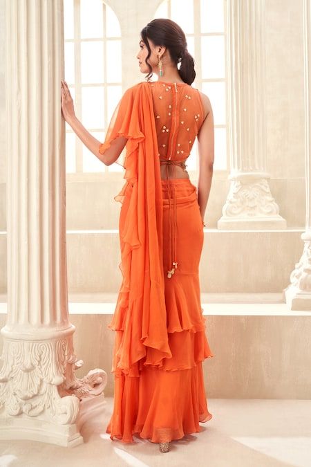 Buy Orange Chiffon Embroidered Applique Pre-draped Saree With Floral Work Blouse For Women by Taavare Online at Aza Fashions. Tiered Saree, Floral Work Blouse, Floral Cutwork, Saree Gowns, Dhoti Saree, Cotton Sarees Handloom, Ruffle Sarees, Orange Chiffon, Applique Work